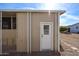 Tan exterior shed with a white door, providing additional storage space at 11596 W Sierra Dawn -- # 132, Surprise, AZ 85378