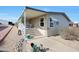 Tan mobile home exterior with covered porch, stairs, and landscaping at 11596 W Sierra Dawn -- # 132, Surprise, AZ 85378
