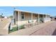 Tan house exterior with covered patio and landscaping at 11596 W Sierra Dawn -- # 132, Surprise, AZ 85378