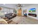 Relaxing living room featuring a fireplace, leather furniture, and a large TV at 11596 W Sierra Dawn -- # 132, Surprise, AZ 85378