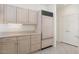 Kitchen area with light wood cabinets, stainless steel refrigerator, and tile flooring at 13811 W Via Tercero --, Sun City West, AZ 85375