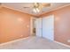 Bedroom with peach walls and ceiling fan at 14595 S Tampico Rd, Arizona City, AZ 85123