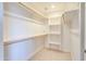 Walk-in closet with shelves and hanging rods at 14595 S Tampico Rd, Arizona City, AZ 85123