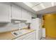 Kitchen features white cabinets, dual sink, and appliances at 1645 W Baseline Rd # 2041, Mesa, AZ 85202