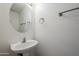 Simple bathroom with pedestal sink and oval mirror at 16649 W Polk St, Goodyear, AZ 85338