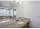 Bathroom boasts granite countertop and large mirror at 16649 W Polk St, Goodyear, AZ 85338