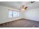Spacious bedroom with large window and ceiling fan at 16649 W Polk St, Goodyear, AZ 85338