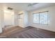 Bright bedroom featuring ceiling fan and window blinds at 16649 W Polk St, Goodyear, AZ 85338