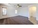 Well-lit bedroom with plush carpeting and ceiling fan at 16649 W Polk St, Goodyear, AZ 85338