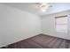 Bright bedroom with ceiling fan and neutral carpet at 16649 W Polk St, Goodyear, AZ 85338
