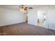 Bright bedroom with ceiling fan and access to bathroom at 16649 W Polk St, Goodyear, AZ 85338