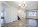 Spacious dining room with tiled floors, chandelier, and staircase at 16649 W Polk St, Goodyear, AZ 85338