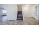 Entryway with tiled floors, staircase, and storage closet at 16649 W Polk St, Goodyear, AZ 85338