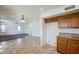 Kitchen with wood cabinets, granite counters, and access to Gathering room at 16649 W Polk St, Goodyear, AZ 85338
