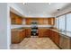 Kitchen with wood cabinets, granite counters, and stainless steel appliances at 16649 W Polk St, Goodyear, AZ 85338