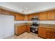 Bright kitchen with stainless steel appliances and wood cabinets at 16649 W Polk St, Goodyear, AZ 85338