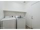 Laundry room with washer, dryer, and shelving at 16649 W Polk St, Goodyear, AZ 85338