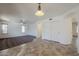 Spacious living room featuring tile floors and ceiling fan at 16649 W Polk St, Goodyear, AZ 85338