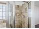 Shower stall with tiled walls and glass enclosure at 16649 W Polk St, Goodyear, AZ 85338