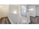 Upstairs hallway with white railing and carpeted floors at 16649 W Polk St, Goodyear, AZ 85338