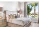 Bright bedroom with plush bed, large window, and water view at 1710 W Glacier Way, Chandler, AZ 85248