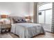 Serene bedroom with upholstered bed, wood floors, and window seating at 1710 W Glacier Way, Chandler, AZ 85248