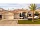 Stunning curb appeal! This home features a tile roof, two-car garage, and lush landscaping at 1710 W Glacier Way, Chandler, AZ 85248