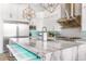 Gourmet kitchen boasts expansive island, stainless steel appliances, and modern white cabinetry at 1710 W Glacier Way, Chandler, AZ 85248