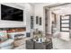 Elegant living room with a fireplace and access to other areas of the home at 1710 W Glacier Way, Chandler, AZ 85248