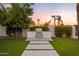 Built-in outdoor kitchen with pathway and lush landscaping at 1710 W Glacier Way, Chandler, AZ 85248