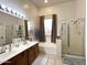Double vanity bathroom with a large soaking tub and shower at 17545 W Canyon Ln, Goodyear, AZ 85338