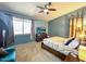 Cozy bedroom featuring a comfortable bed, ceiling fan, and large windows for ample natural light at 17545 W Canyon Ln, Goodyear, AZ 85338