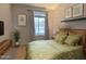 Cozy bedroom with a large window, decorative artwork, and green bedding at 17545 W Canyon Ln, Goodyear, AZ 85338