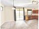 Open floorplan kitchen and dining area with tile floor, light counters, and sliding glass door at 17545 W Canyon Ln, Goodyear, AZ 85338