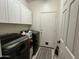 Laundry room with washer, dryer, and cabinets at 17545 W Canyon Ln, Goodyear, AZ 85338