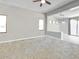 Bright living room with neutral tones, carpet flooring, and seamless flow to dining area at 17545 W Canyon Ln, Goodyear, AZ 85338