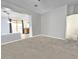 Open concept living room with carpeted floors and easy access to kitchen and backyard at 17545 W Canyon Ln, Goodyear, AZ 85338