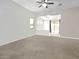 Bright living room featuring neutral tones, a ceiling fan, and an open floorplan to the backyard at 17545 W Canyon Ln, Goodyear, AZ 85338