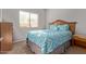 Bedroom with wood dresser and large window at 18412 N Primrose Dr, Maricopa, AZ 85138