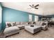 Spacious living room with large sectional sofa and ceiling fan at 23805 W Levi Dr, Buckeye, AZ 85326