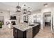 Bright kitchen with a large kitchen island, stainless steel appliances, and an open floor plan to the living room at 25516 S 205Th Way, Queen Creek, AZ 85142