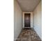 Interior entryway with dark wood door and tile flooring at 25921 W Kimberly Way, Buckeye, AZ 85396