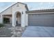 View of home's exterior, showcasing the garage and entrance at 25921 W Kimberly Way, Buckeye, AZ 85396