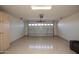 Bright garage featuring overhead door and epoxy floor at 25921 W Kimberly Way, Buckeye, AZ 85396