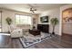 Bright living room with hardwood floors and comfortable seating at 25921 W Kimberly Way, Buckeye, AZ 85396