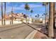 Inviting entrance to the community with palm trees at 2801 N Litchfield Rd # 37, Goodyear, AZ 85395