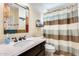 Bathroom with updated vanity and striped shower curtain at 3118 N 114Th Dr, Avondale, AZ 85392