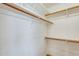 Walk-in closet with wood shelving and hanging rods at 3118 N 114Th Dr, Avondale, AZ 85392