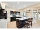 Modern kitchen with dark wood cabinets and a breakfast bar at 3118 N 114Th Dr, Avondale, AZ 85392