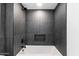 Clean bathroom with soaking tub and dark tile at 3807 N 55Th Pl, Phoenix, AZ 85018